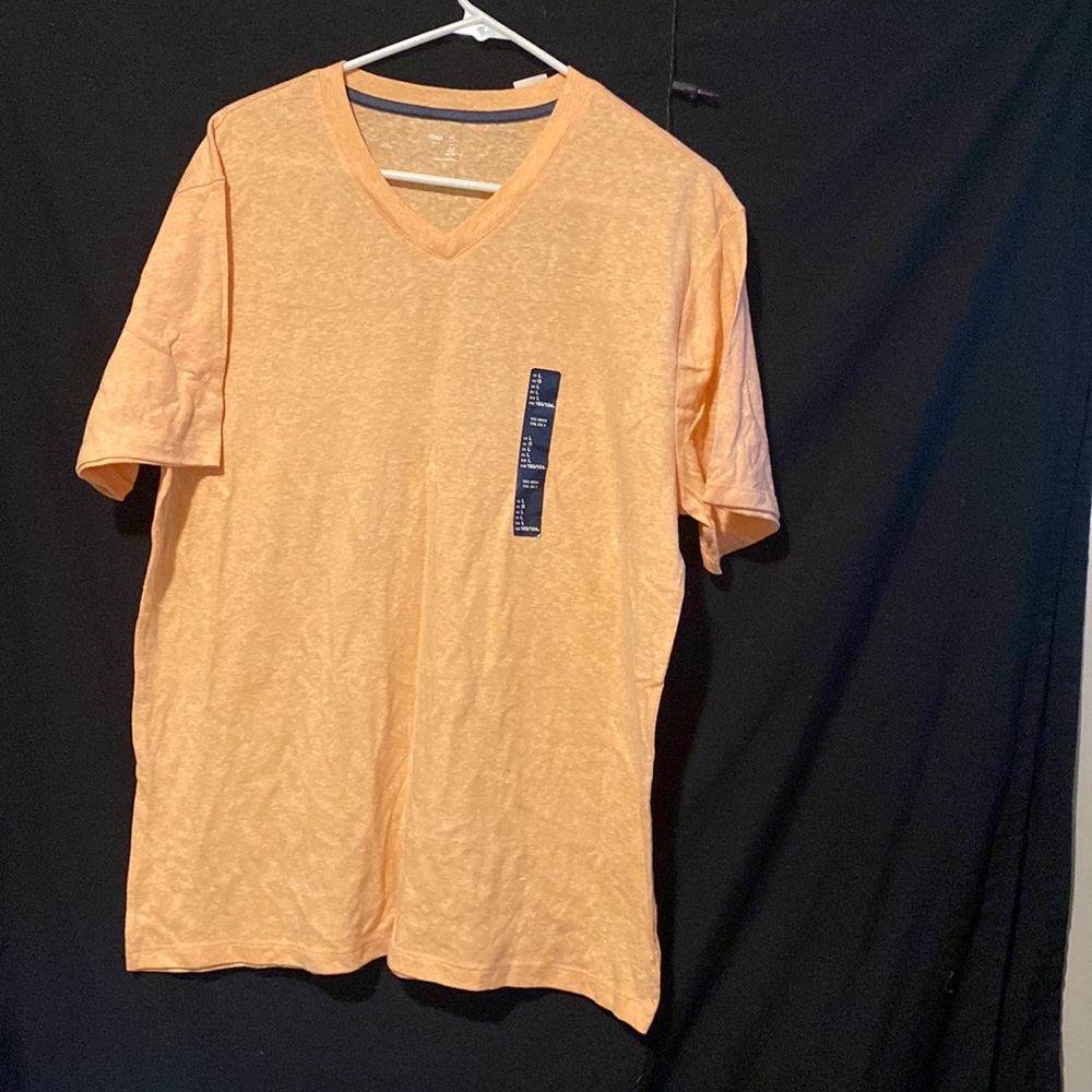 Its a gap t-shirt that is a orange/pink color. The shirt is large